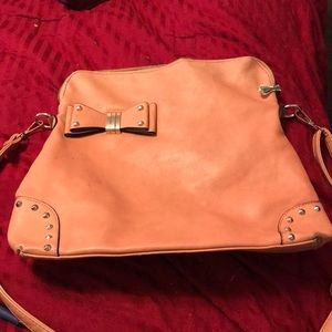 Light tan cross body purse.
